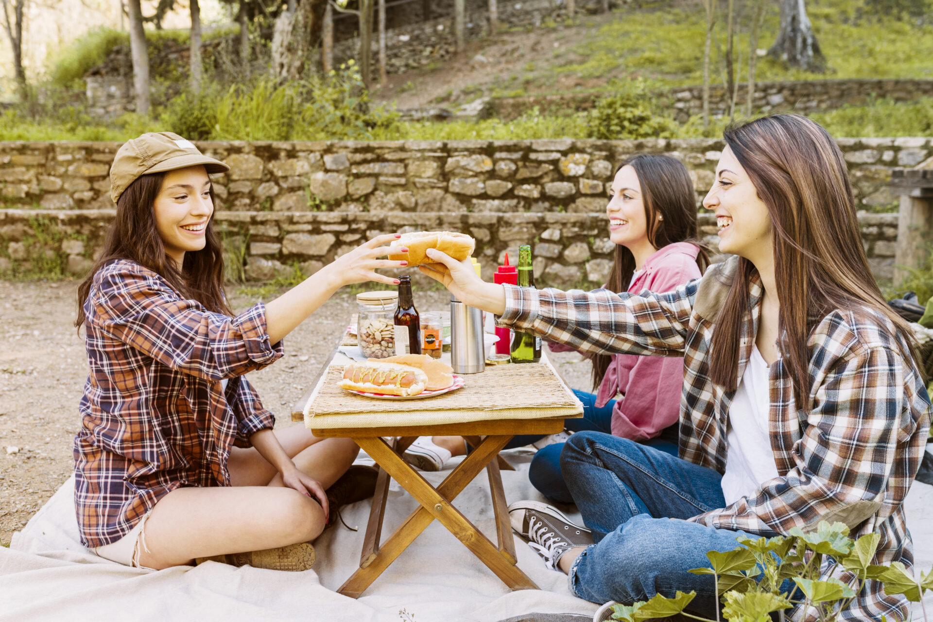 Girls are enjoying lunch on picnic table